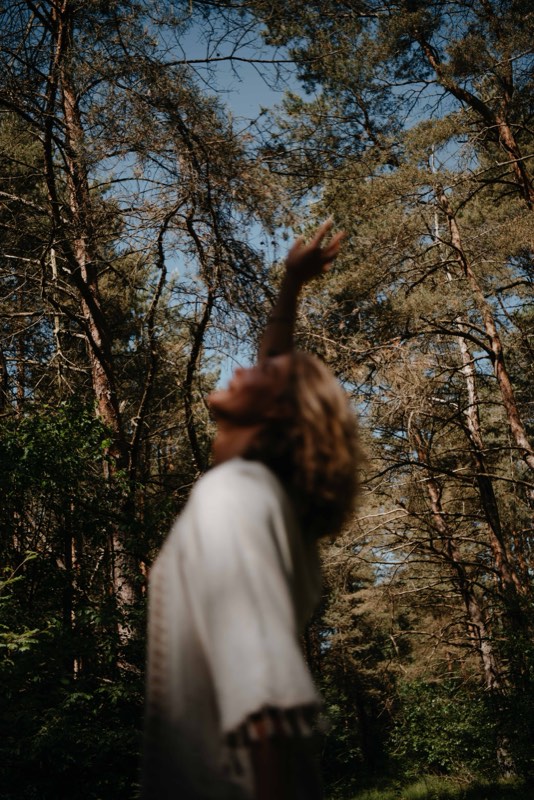Figure in white among trees