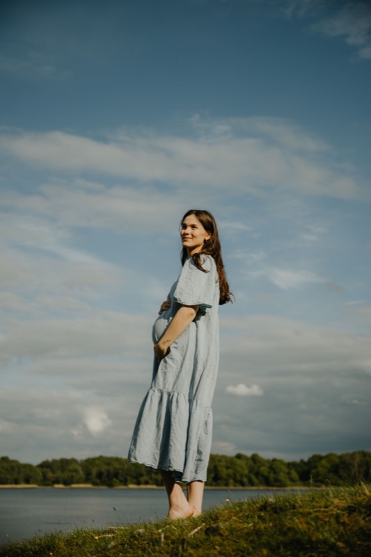 Figure in a light dress by the water